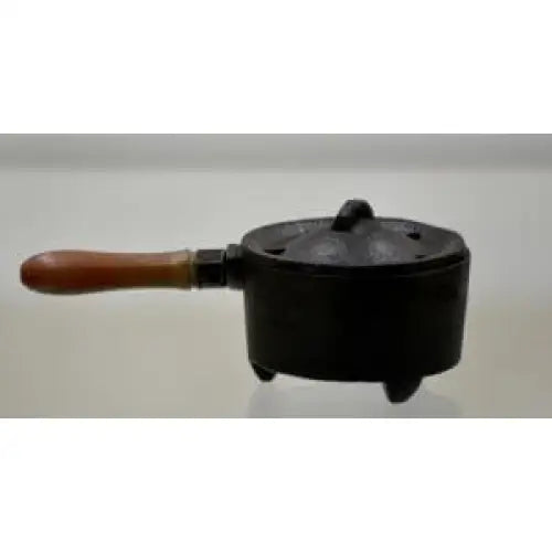 large cauldron with wooden handle